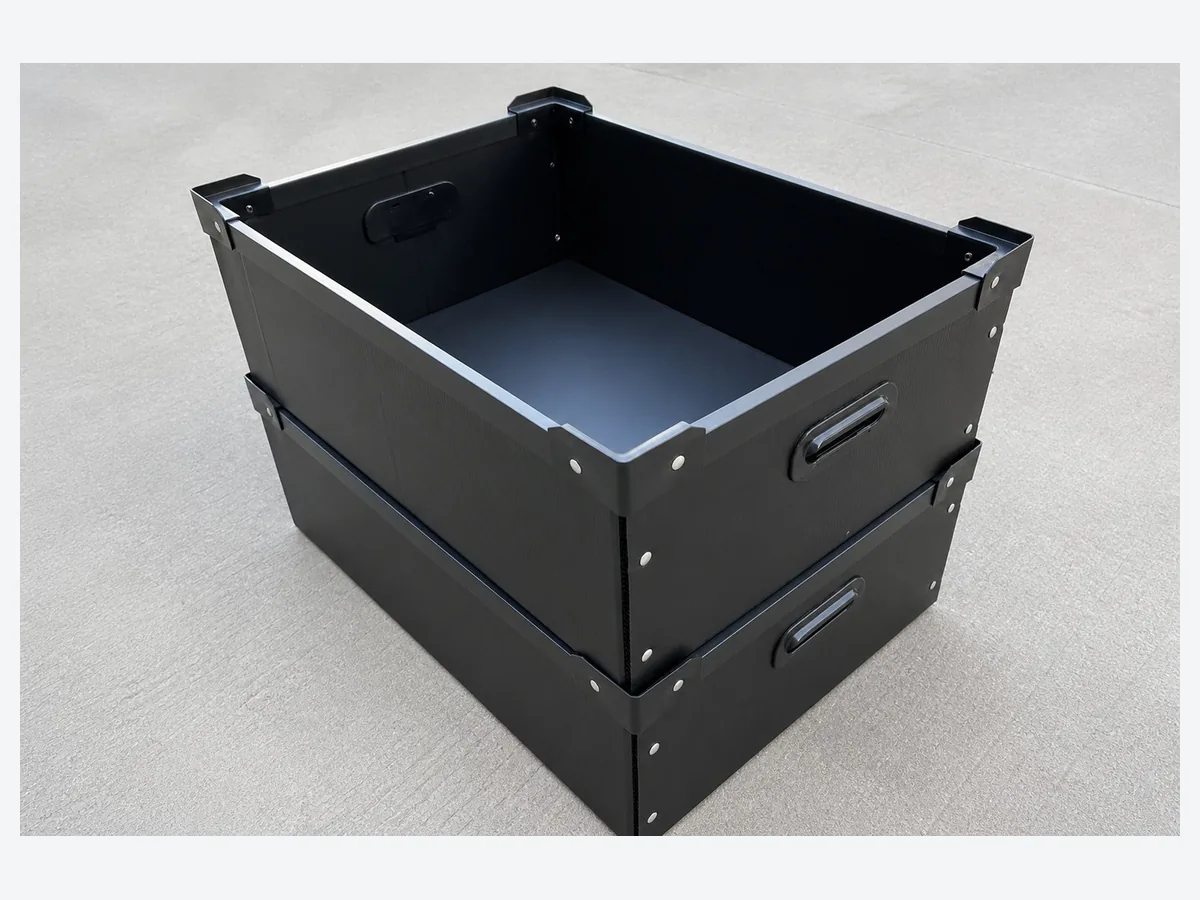 Two black PP corrugated returnable boxes with reinforced edges and handholds