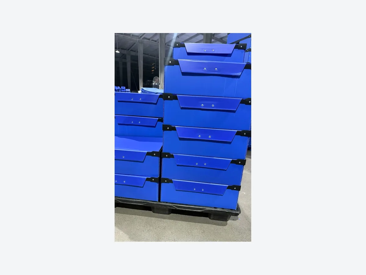Blue open-front PP corrugated storage bins stacked for warehouse picking